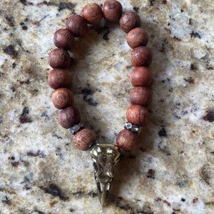 Metal and wood beaded bracelet with rhinestone and brass detail. 6in. Elastic.